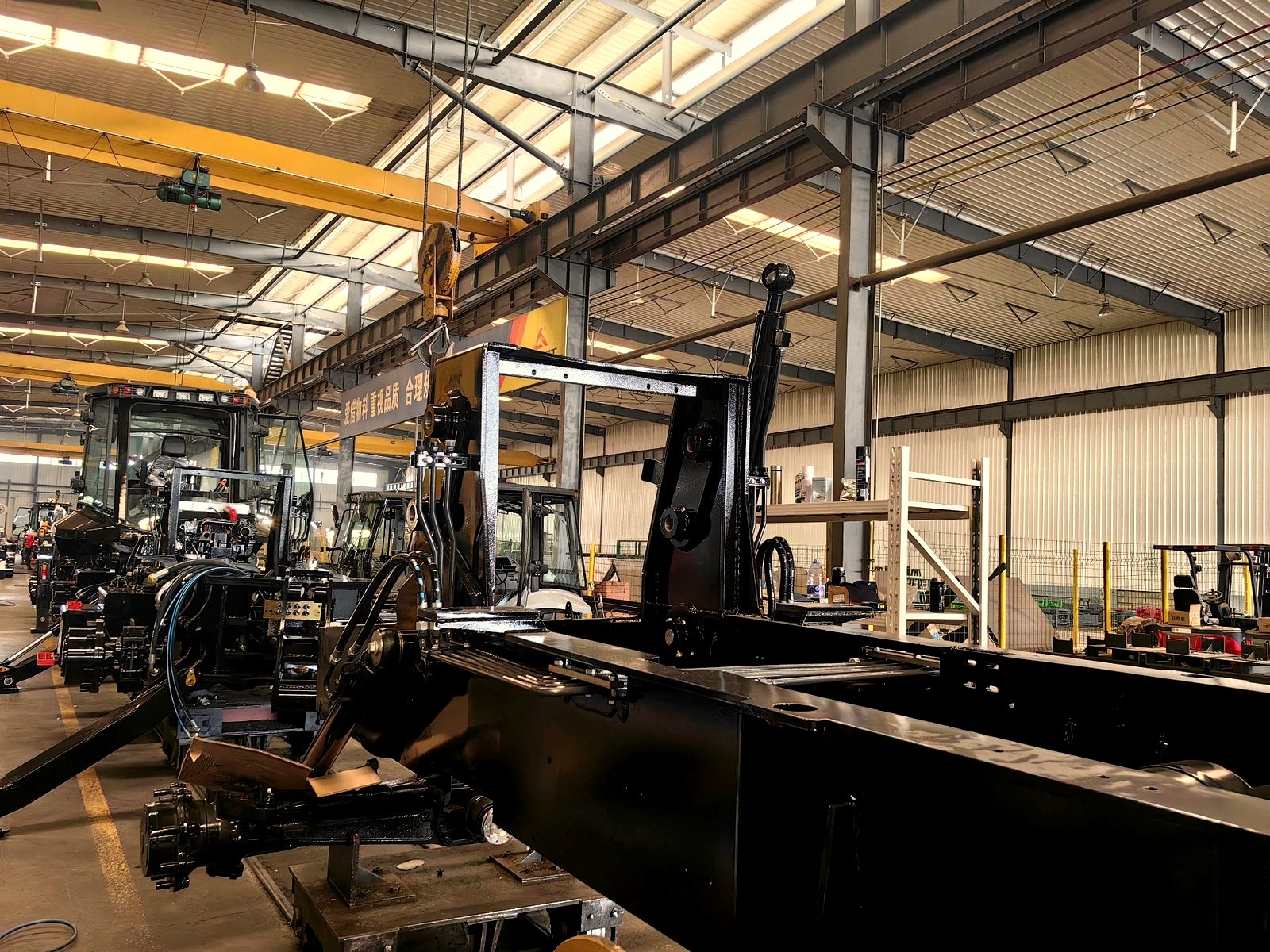 Backhoe loader safety operation in factory workshop