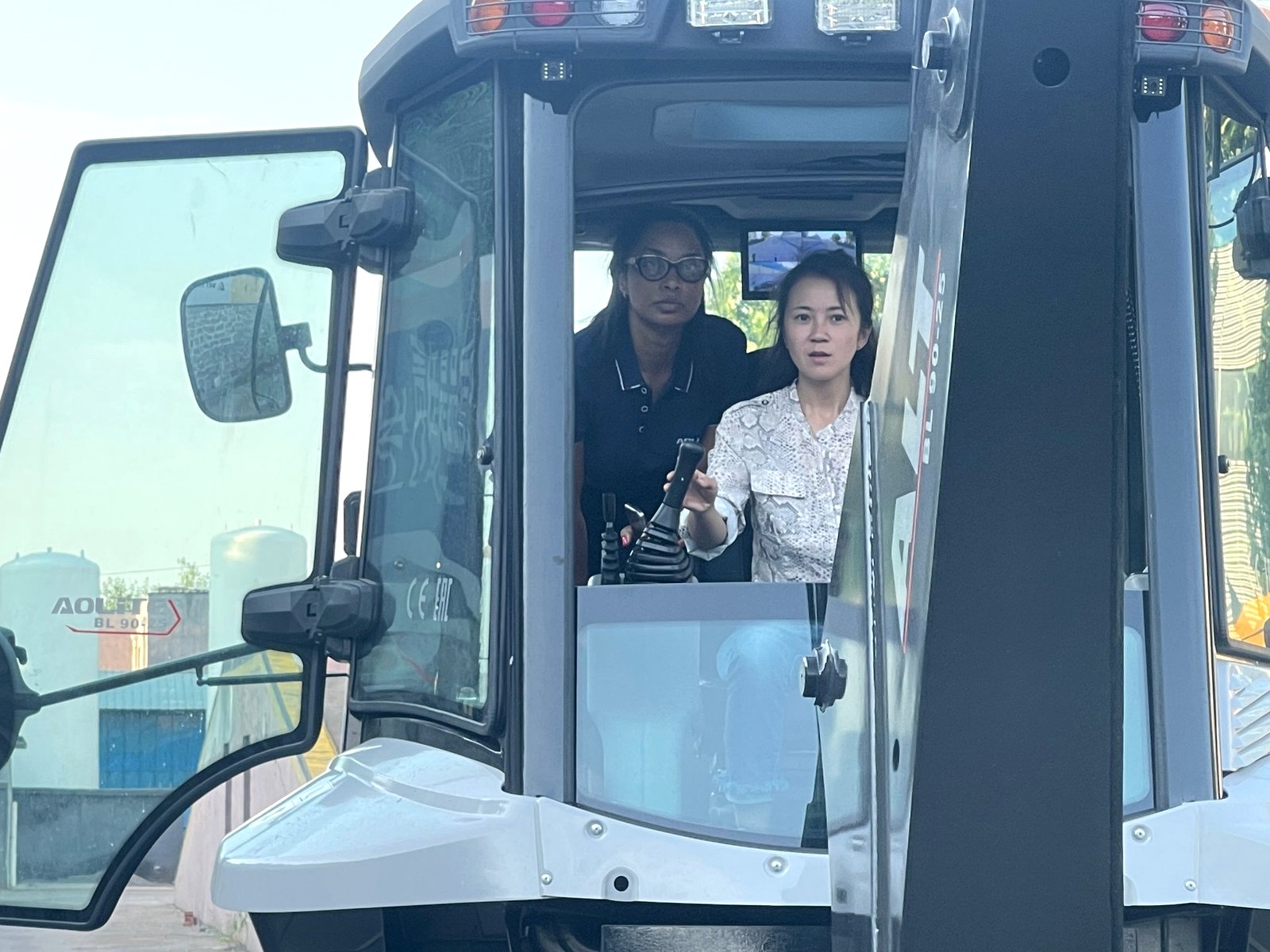 Client learning the joystick controls — backhoe loader