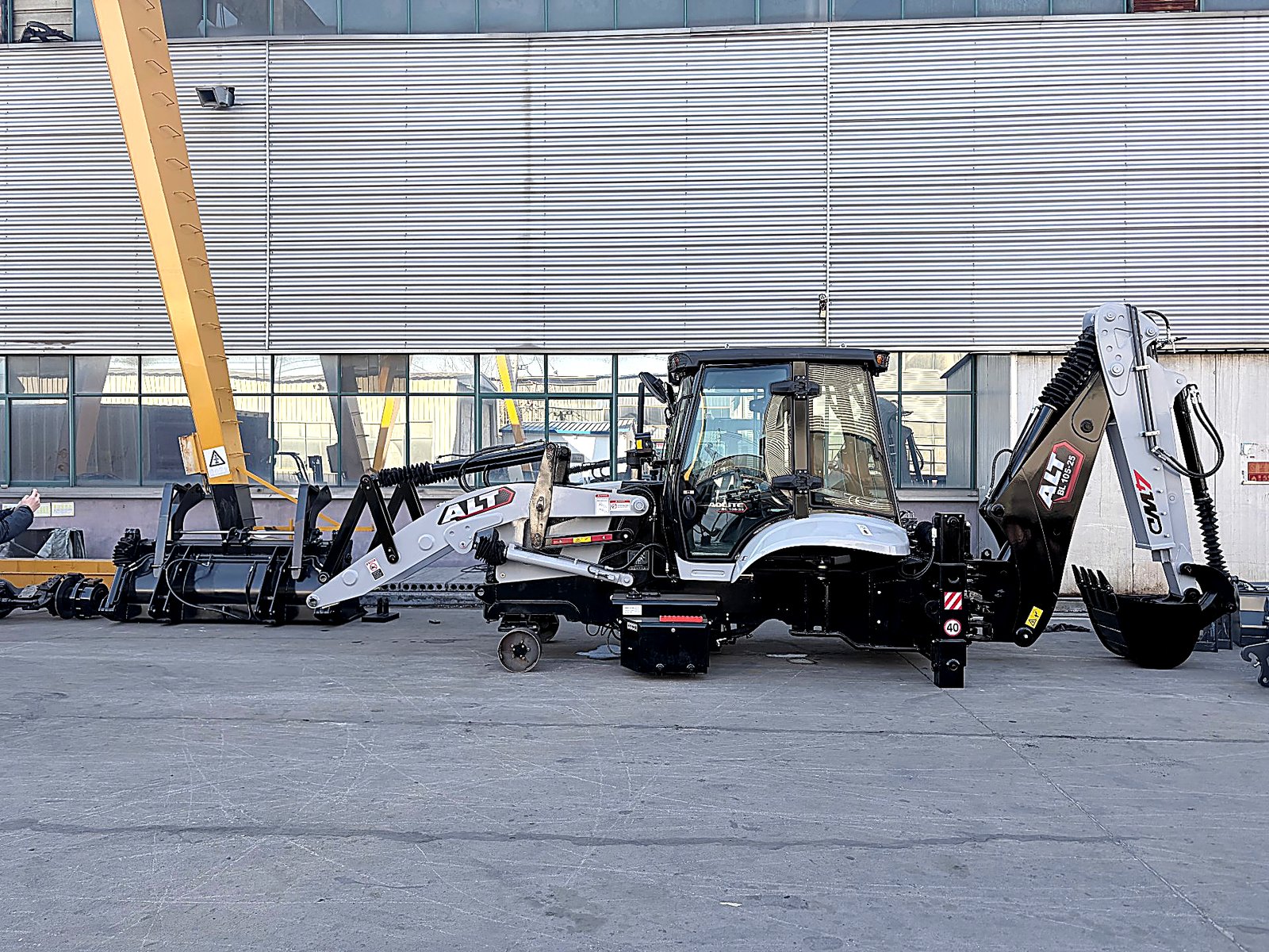Backhoe loader being loaded into a shipping container